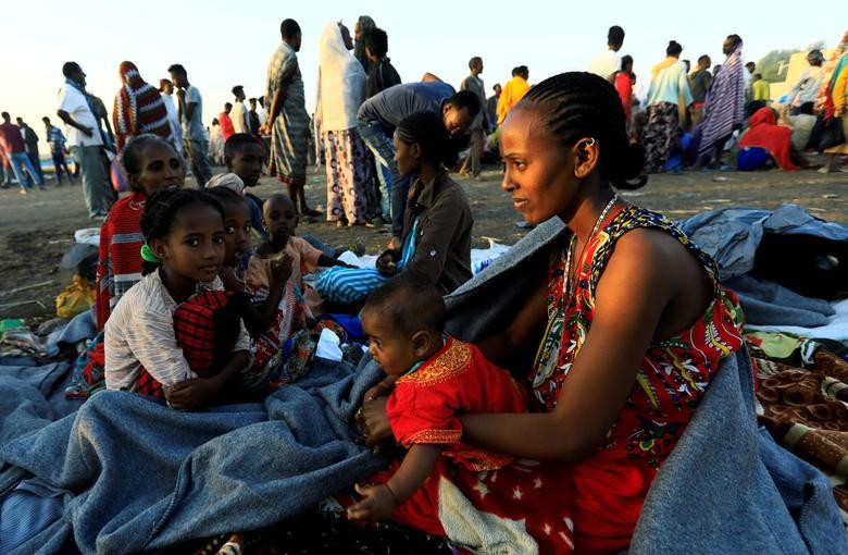 Ethiopian women who fled the ongoing fighting in Tigray region gather in Hamdayet village near the Setit river on the Sudan-Ethiopia border in eastern Kassala state, Sudan November 22. REUTERS/Mohamed Nureldin Abdallah
